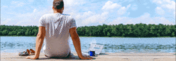 Man by lake with coffee